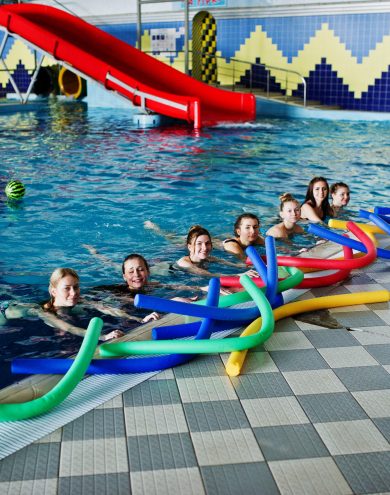fitness-group-girls-doing-aerobical-excercises-swimming-pool-aqua-park-sport-leisure-activities-scaled.jpg